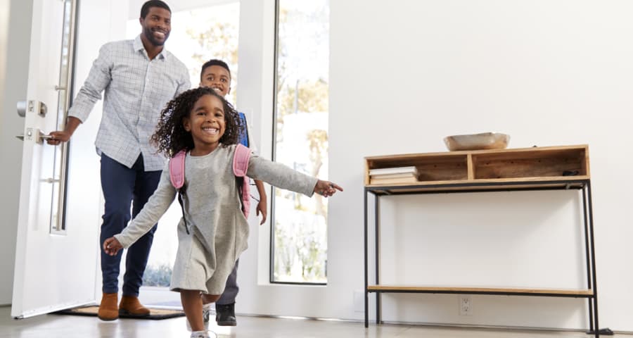Father and kids coming through the front door