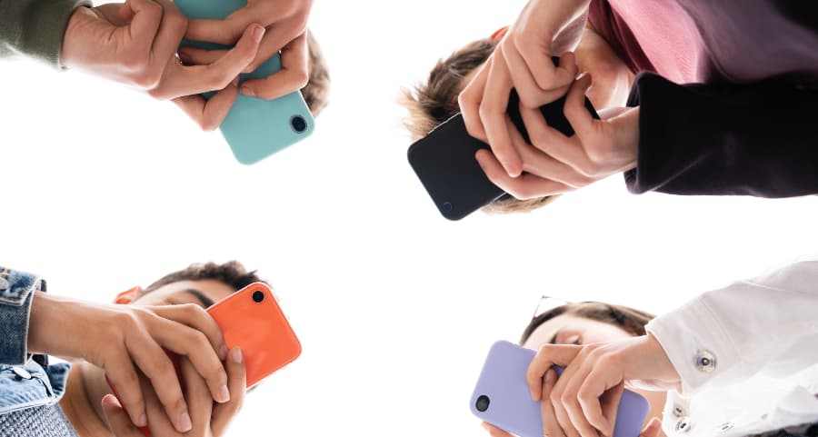 Teens using cell phones to access social media in Lima